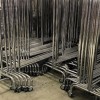 Stackable metal coat rack with 150cm wide wheels. Detail. 